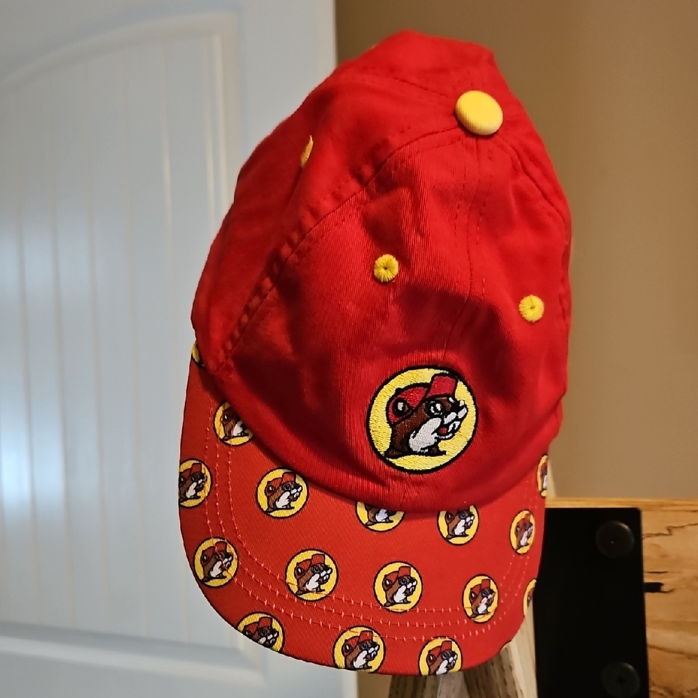 Vibrant Red and Yellow Hat with Decorative Emblems